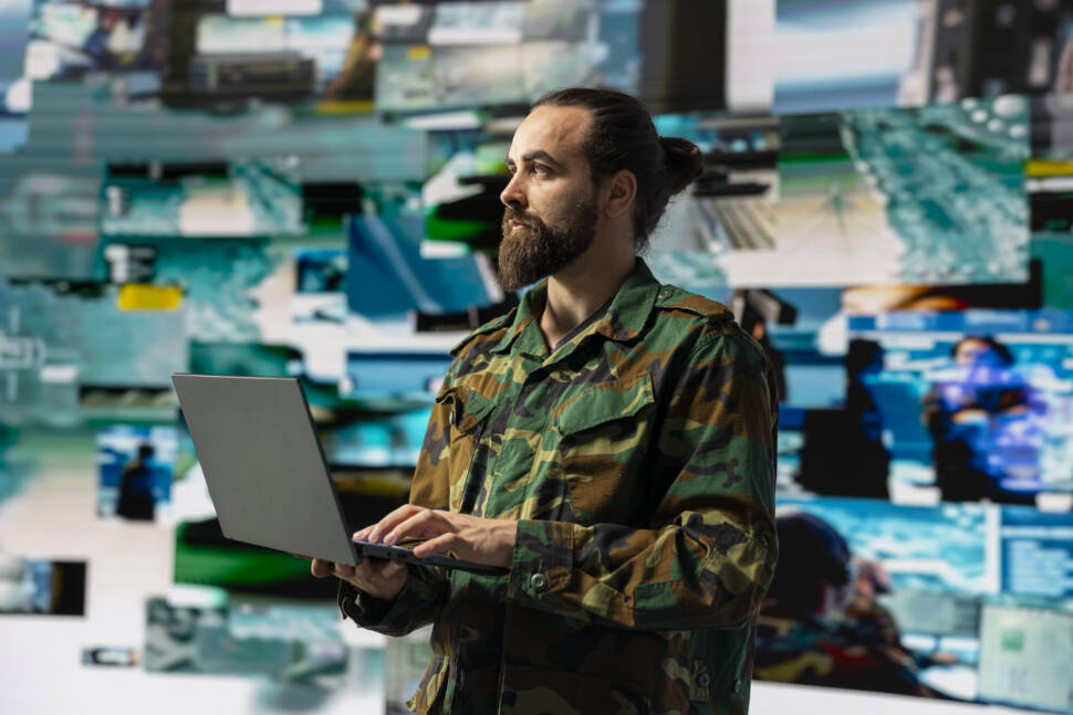 Male soldier operates in a virtual war zone using digital technology